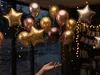 Floating luxury birthday balloons and golden confetti